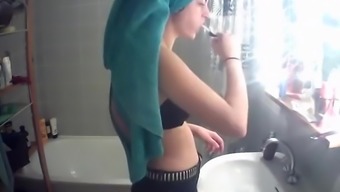 Petite teen girl spied while washing teeth