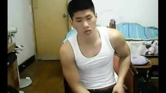 Beefy Chinese hunk takes off his clothes and jerks off his cock on webcam.