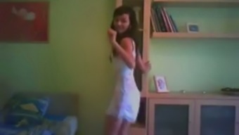 Dark haired slender amateur chick dances in her white dress for me