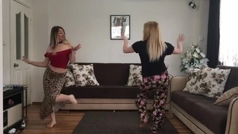 Two blonde girls dancing at home