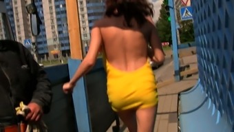 Fabulous young chick in yellow dress shows her perky breasts in public places