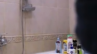 Voluptuous brunette milf caught masturbating in the shower