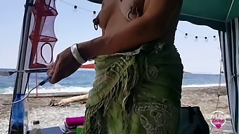 Nippleringlover - Horny milf is topless on a nude beach, spreading her pierced pussy wide open showing off big pierced nipples and