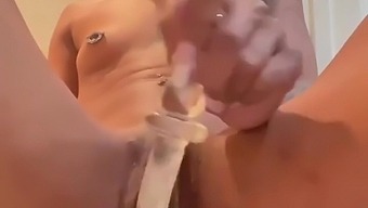A sex toy brings a black girl to orgasm with its silver handle
